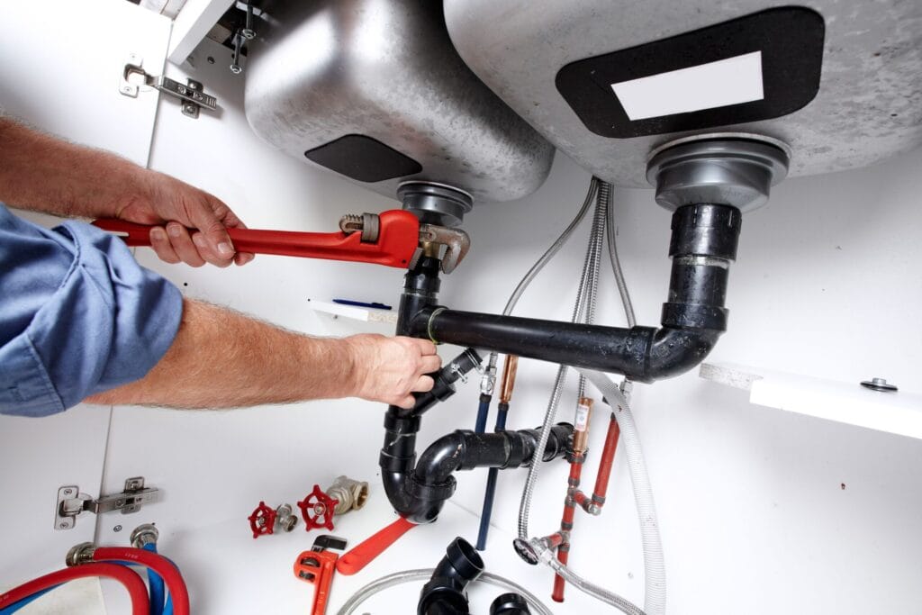 Homestead Plumbing Pros fixing under sink plumbing and drain pipes