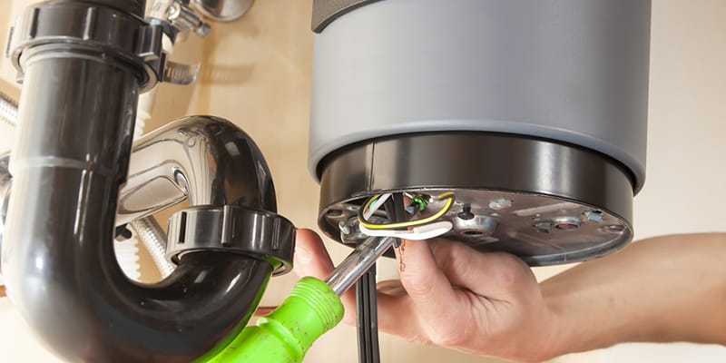 Homestead, Florida plumber servicing water heater pipe connection