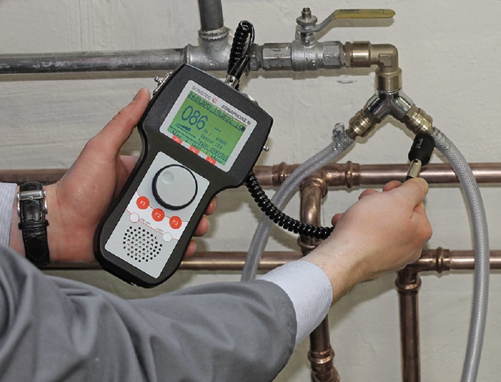 Plumber testing pipes with electronic leak detection equipment in Homestead