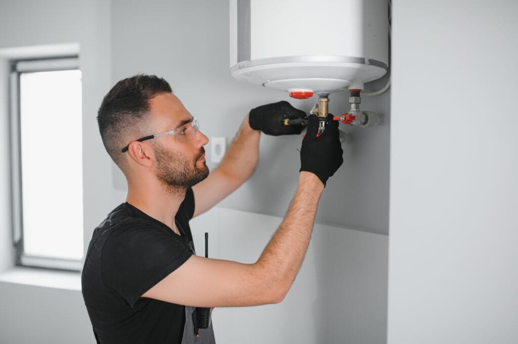 Technician performing water heater maintenance in Homestead